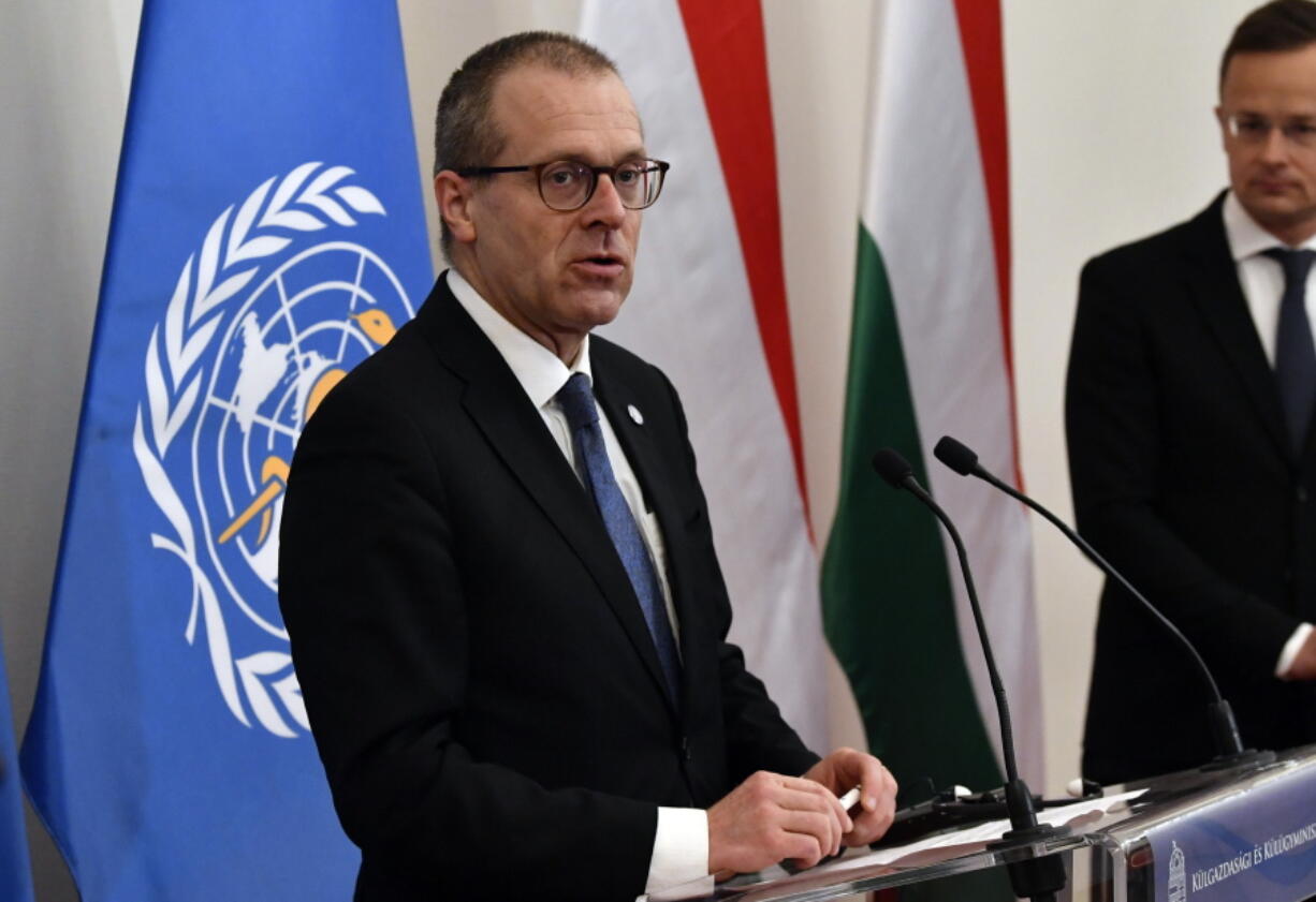 FILE - Hans Kluge, Regional Director for Europe at the World Health Organization (WHO) hold a press conference with Hungarian Minister of Foreign Affairs and Trade Peter Szijjarto, right, at the Ministry of Foreign Affairs and Trade in Budapest, April 21, 2021. The director of the World Health Organization's Europe office said the continent is now facing a "plausible endgame" to the pandemic and that the number of coronavirus deaths is now starting to plateau. During a press briefing on Thursday, Feb. 3, 2022 WHO's Dr. Hans Kluge said there is a "singular opportunity" for countries to take control of COVID-19's transmission.