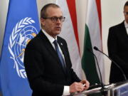 FILE - Hans Kluge, Regional Director for Europe at the World Health Organization (WHO) hold a press conference with Hungarian Minister of Foreign Affairs and Trade Peter Szijjarto, right, at the Ministry of Foreign Affairs and Trade in Budapest, April 21, 2021. The director of the World Health Organization's Europe office said the continent is now facing a "plausible endgame" to the pandemic and that the number of coronavirus deaths is now starting to plateau. During a press briefing on Thursday, Feb. 3, 2022 WHO's Dr. Hans Kluge said there is a "singular opportunity" for countries to take control of COVID-19's transmission.