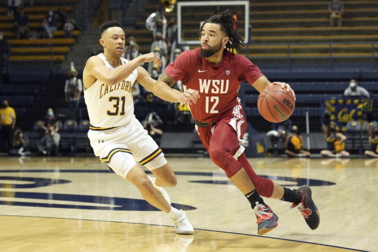 Washington State guard Michael Flowers (12) dribbles while defended by California guard Jordan Shepherd (31) during the first half in an NCAA college basketball game in Berkeley, Calif., Saturday, Feb. 5, 2022.