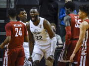 Oregon center Franck Kepnang (22) reacts after making basket and being fouled, as Oregon forward Eric Williams Jr. (50) stands at left and Washington State guard Noah Williams (24), forward Mouhamed Gueye (35) and forward DJ Rodman (11) watch during the second half of an NCAA college basketball game Monday, Feb. 14, 2022, in Eugene, Ore.