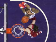 Washington's Nate Roberts, top, grabs a rebound next to Washington State's Tyrell Roberts during the first half of an NCAA college basketball game Saturday, Feb. 26, 2022, in Seattle.