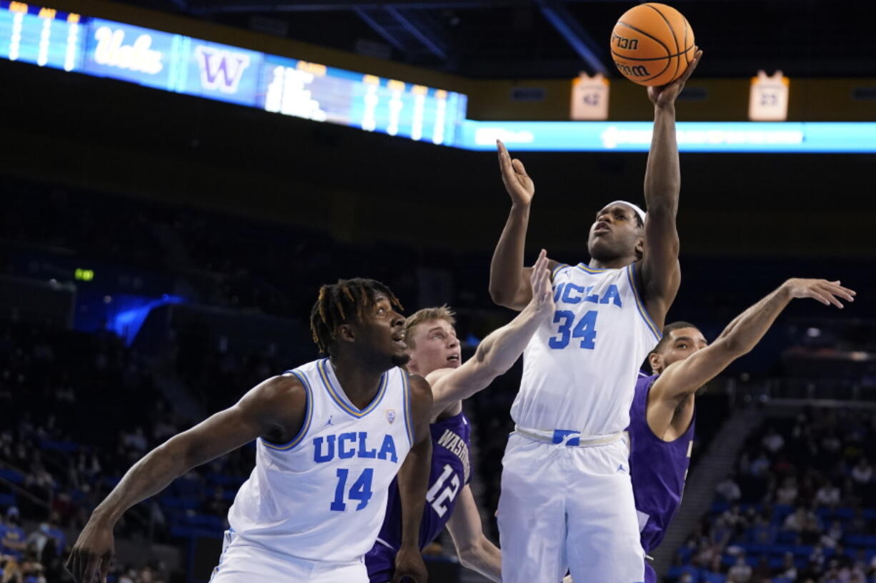 UCLA guard David Singleton (34) scores against Washington during the second half of an NCAA college basketball game Saturday, Feb. 19, 2022, in Los Angeles.