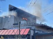 A roof fire burns in the former Red Lion at the Quay on Tuesday afternoon. The building was undergoing demolition work when the three-alarm fire began.