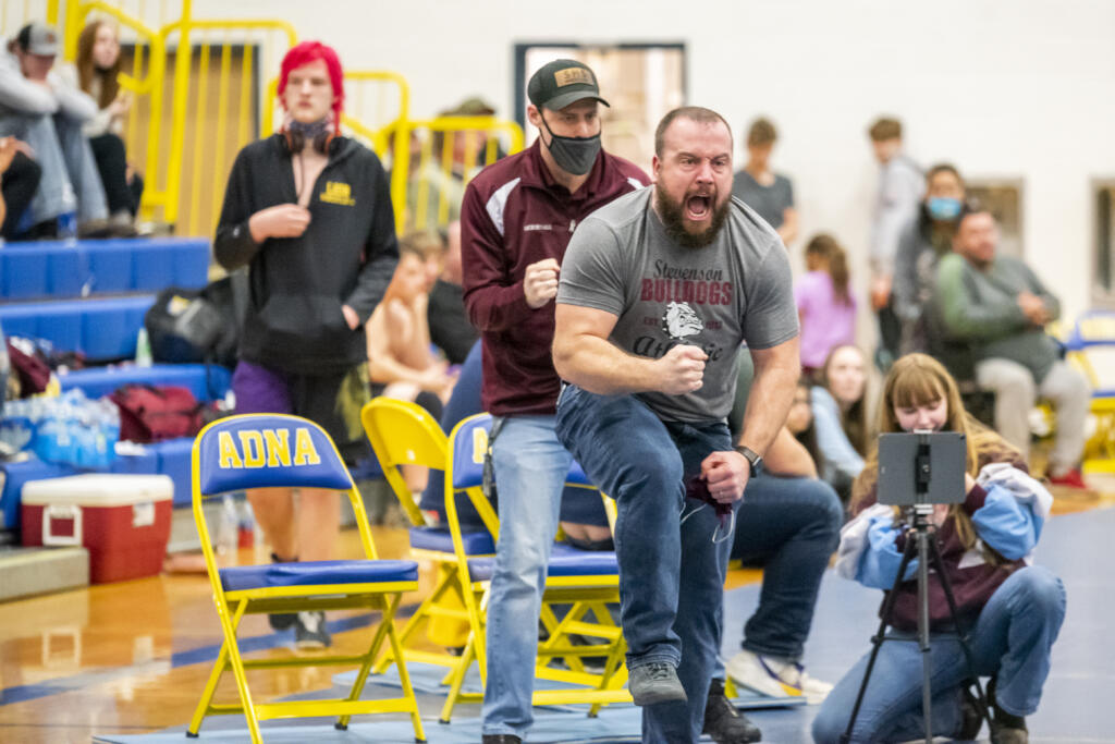 Stevenson boys wrestling coach yells in celebration during the 1B/2B Region 1 boys wrestling tournament at Adna on Saturday.