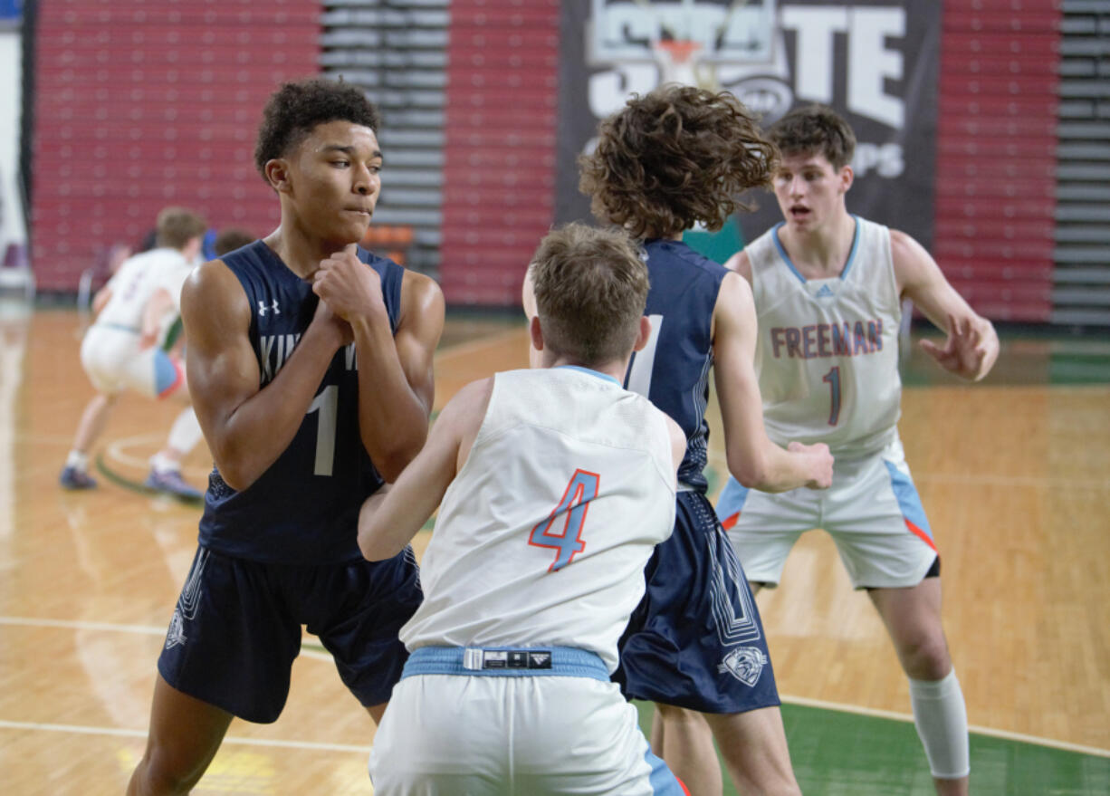 King's Way Christian guard Jamison Duke (1) sets a screen for teammate Giovanny Evanson in a Class 1A boys basketball state tournament game against Freeman on Wednesday in Yakima.