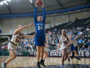 La Center's Kylee Stephens, center, reaches out to secure a lob pass into the post between Colville defenders Kaelyn Malone, left, and Mckenna Reggear, right, during a Class 1A loser-out state game Wednesday at the Yakima Valley SunDome.