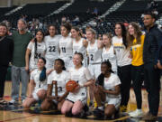 The Hudson’s Bay girls basketball team poses with the sixth-place trophy at the Class 2A state tournament on Saturday, March 5, 2022 in Yakima.