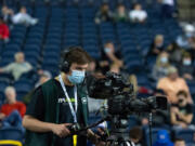 Columbia River High School junior Ethan Reyes operates a courtside camera for VPS GameTime in a 4A State Boys Basketball semifinal on  Friday, March 4, 2022, at the Tacoma Dome.