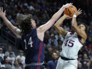 Gonzaga's Rasir Bolton (45) shoots over Saint Mary's Kyle Bowen (14) during the first half of an NCAA college basketball championship game at the West Coast Conference tournament Tuesday, March 8, 2022, in Las Vegas.