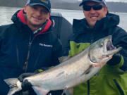 Guide Bill Monroe, (left), with a client and a nice spring Chinook caught in the Columbia River during last year's spring salmon fishery. Projections for the spring Chinook run are up this year, and anglers should see better fishing than the past few years.