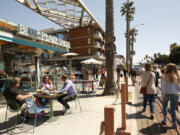 People dine at Blue Plate Taco in Santa Monica, Calif., as people take advantage of the warm weather during the COVID-19 spring break in Southern California on March 29, 2021.