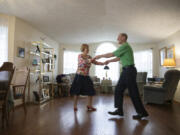 Jim Ferris, 82, and Thea Sturm, 89, dance in their Hazel Dell living room on Saturday. The pair met at a dance class at the Luepke Community Center three years ago and have danced together since then.