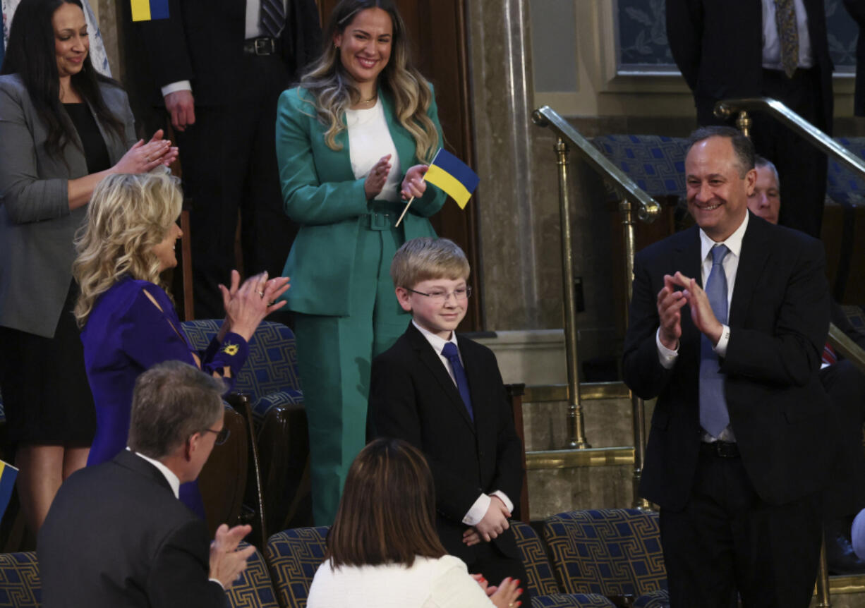 U.S. first lady Jill Biden and second gentleman Doug Emhoff join in applause for 13-year-old diabetes patient and advocate Joshua Davis of Midlothian, Virginia as he is mentioned by President Joe Biden during his State of the Union address to a joint session of the U.S. Congress in the House of Representatives Chamber at the Capitol in Washington, D.C., on March 1, 2022.