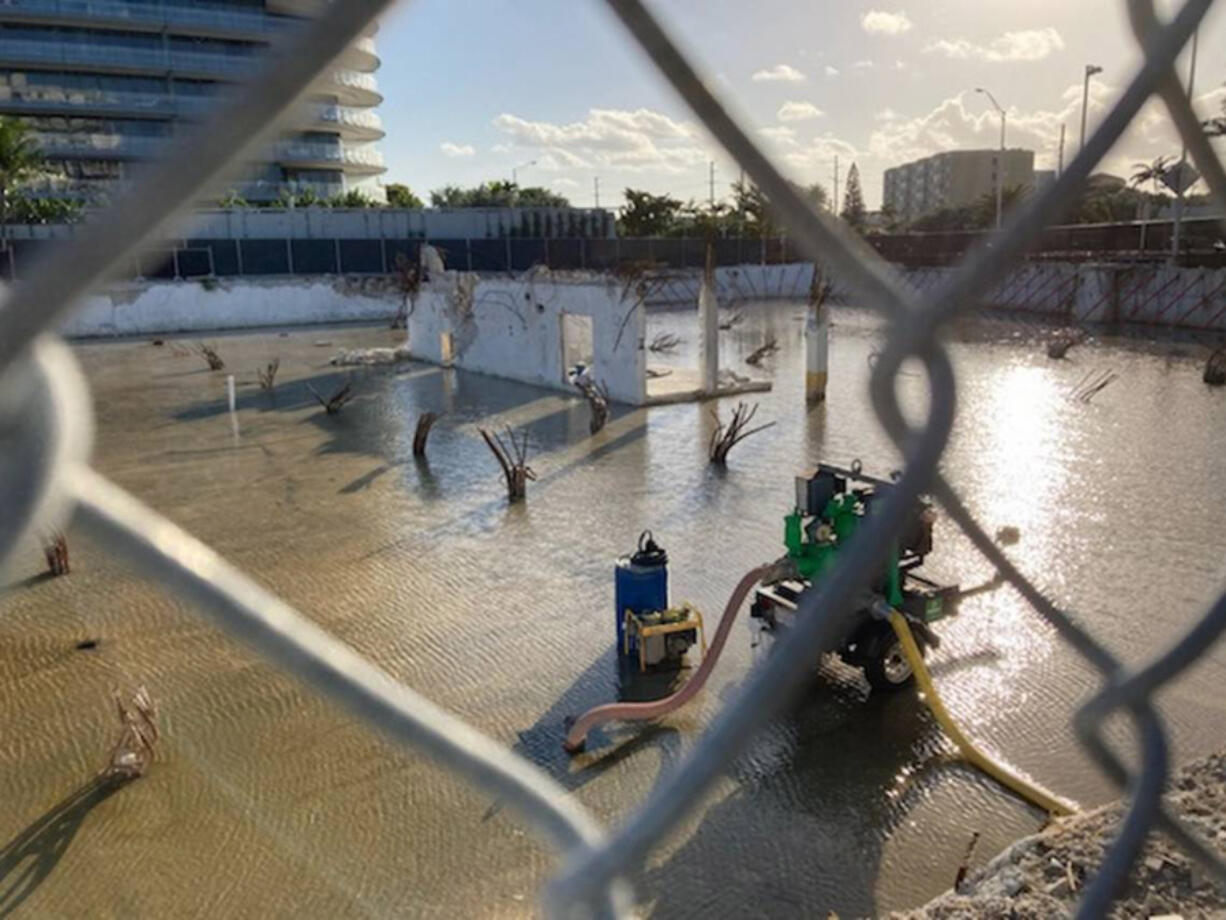 Photos taken Christmas morning, 2021, show the impact of tidal and rain flooding on the underground garage at Champlain Towers South, in Surfside. New research shows sea rise caused the garage to flood more often.