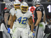 Los Angeles Chargers outside linebacker Uchenna Nwosu (42) reacts after a play against the Las Vegas Raiders during the first half of an NFL football game, Sunday, Jan. 9, 2022, in Las Vegas.