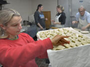 Melanya Humeniuk checks the pierogies to make sure they are tightly pinched together before they are boiled. Volunteers at St. Michael The Archangel Ukrainian Catholic Church in Baltimore have been busy all week making Ukrainian specialties, including potato and sauerkraut pierogi. All the profits will be donated to help Ukrainians at war with Russia.