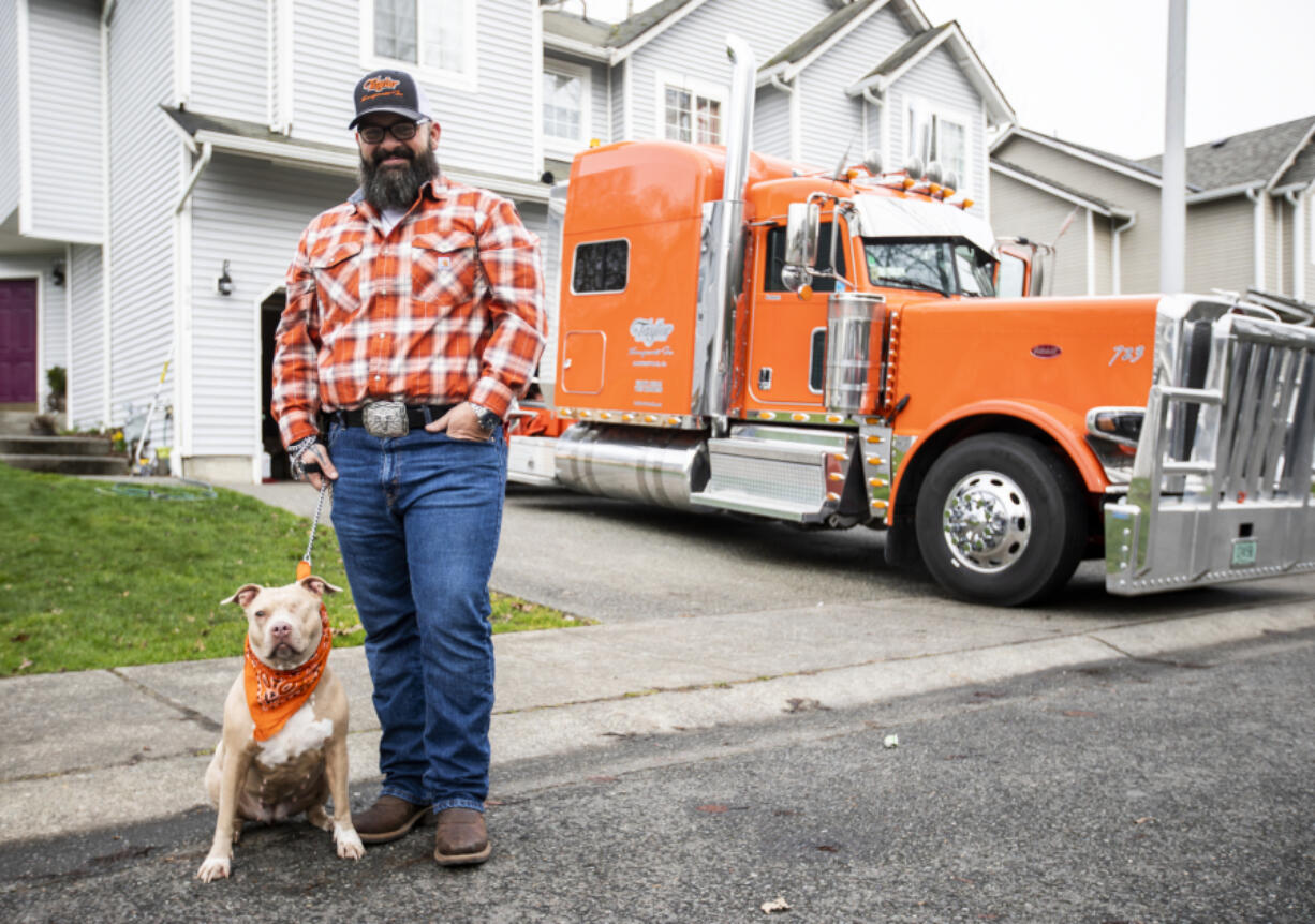 Shawn ???Stogie??? Dirksen and his one-eyed pitbull Bonnie and his truck ???The Orange Crush??? in Lake Stevens on Tuesday, March 1, 2022.