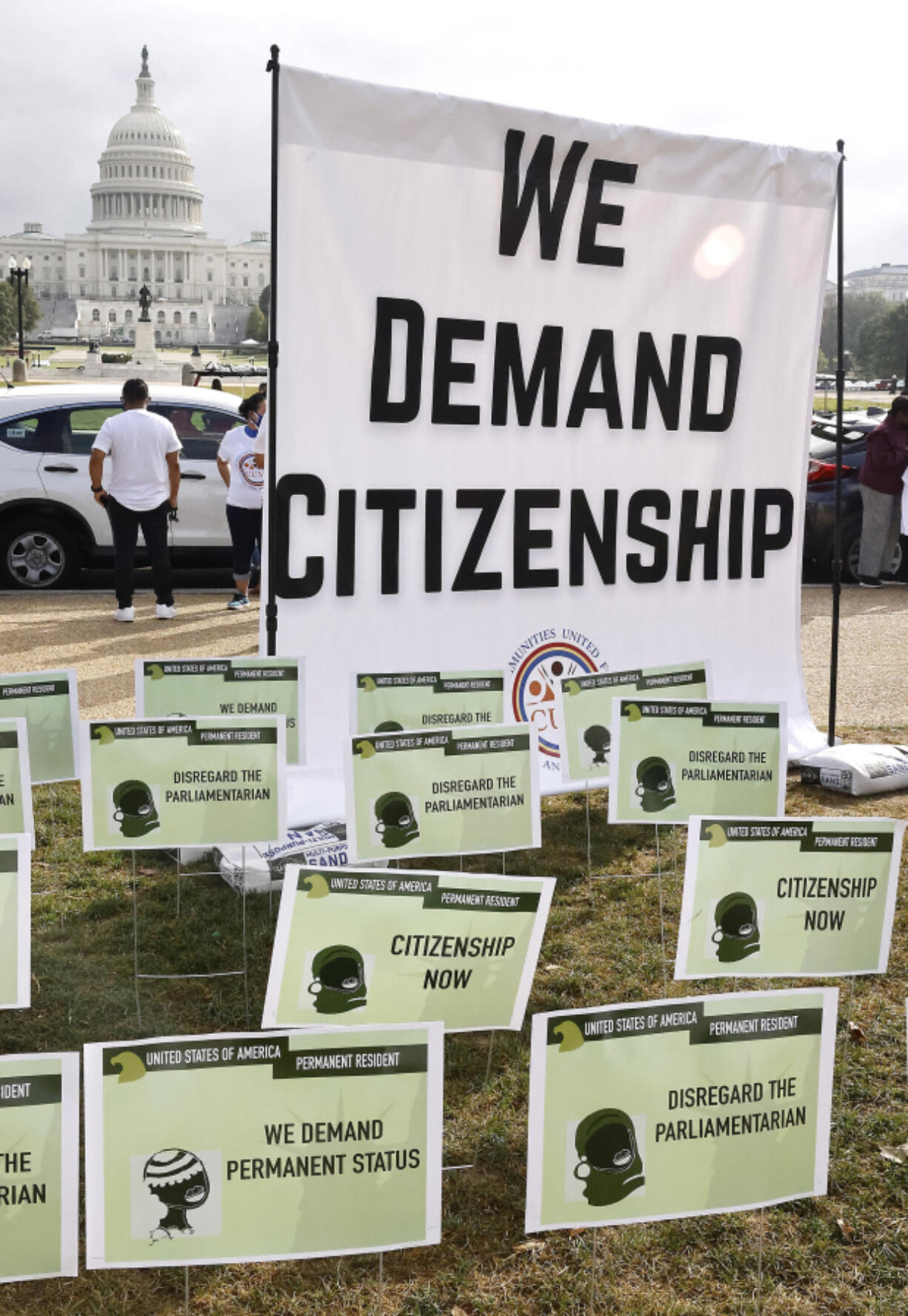 Immigrants install hundreds of green card placards symbolizing their demand for U.S. citizenship in front of the U.S. Capitol Building on Oct. 13, 2021, in Washington, D.C.