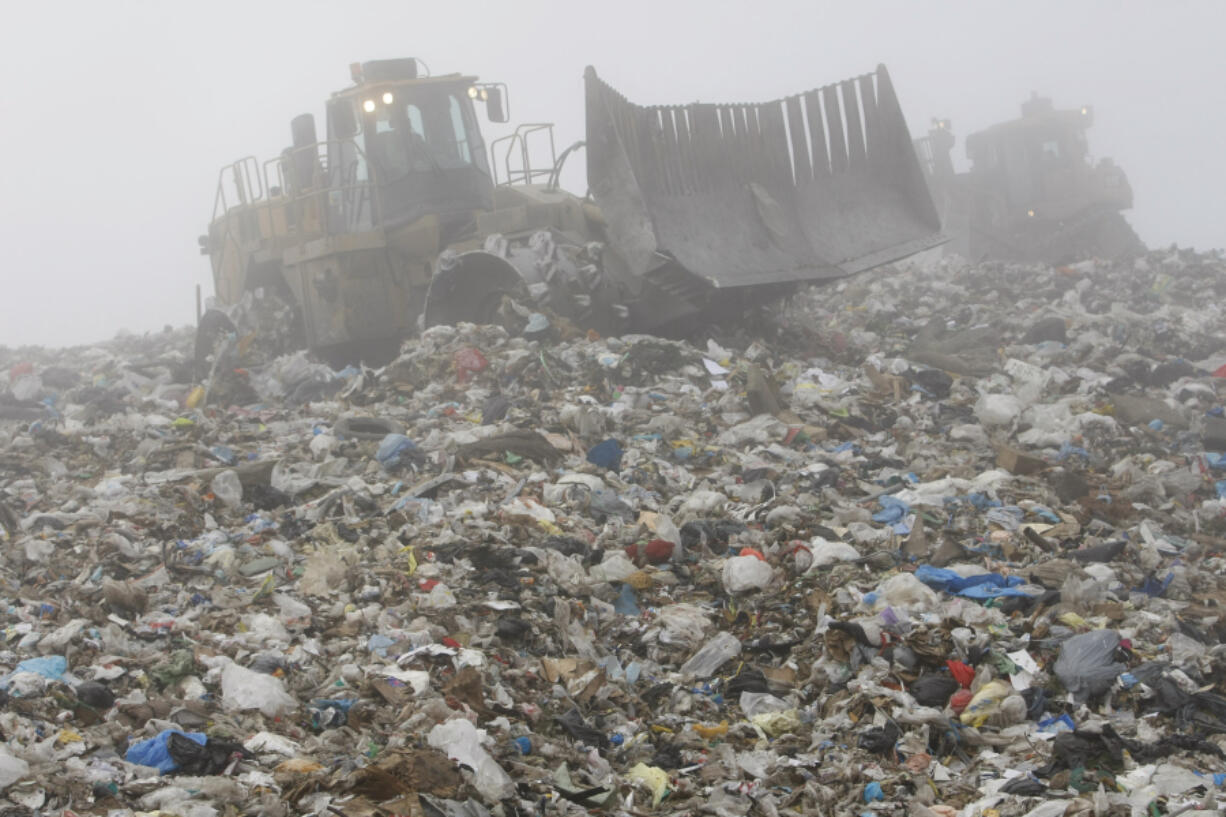 Photos by Marcio Jose Sanchez/The Associated Press 
 A tractor sorts garbage in December at the Altamont landfill, owned by Waste Management, in Livermore, Calif. ORG XMIT: FX108