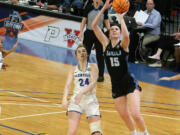 Western Washington?s Brooke Walling (15) goes past Glenville State?s Abby Stoller for two of her career-high 27 points during the NCAA Division II women?s championship game Friday at Birmingham, Ala.