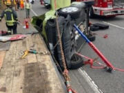 The car a 72-year-old Vancouver woman was extricated from after she crashed into an Oregon woman changing lanes Wednesday morning southbound on Interstate 5. The Vancouver woman's Kia Soul slid into a flatbed trailer that road crews were using on the shoulder of the freeway.