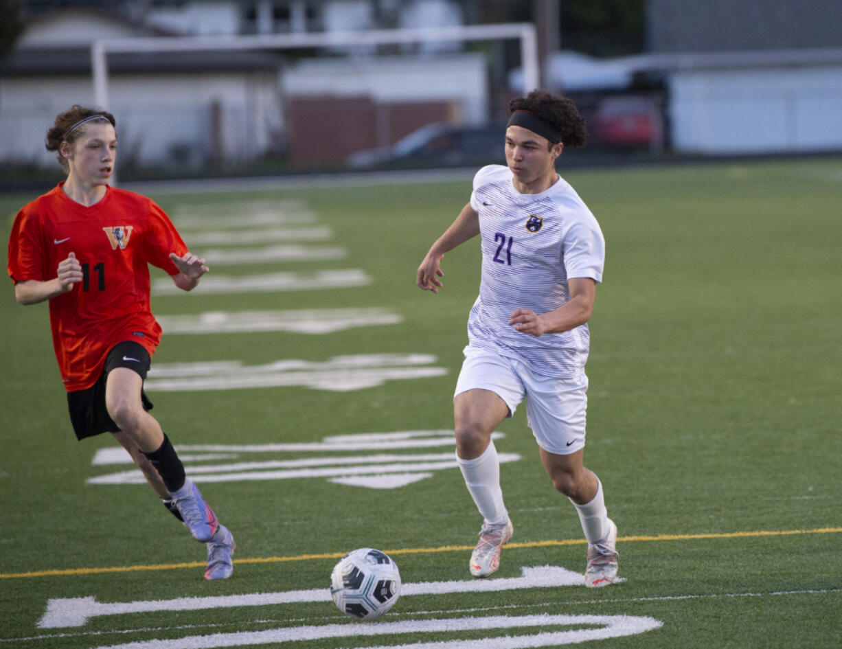 Columbia River's Rowen Naylor (21) dribbles the ball against Washougal's Bailey Boyle during the Rapids' win over Washougal on Wednesday, March 30, 2022 in Washougal.