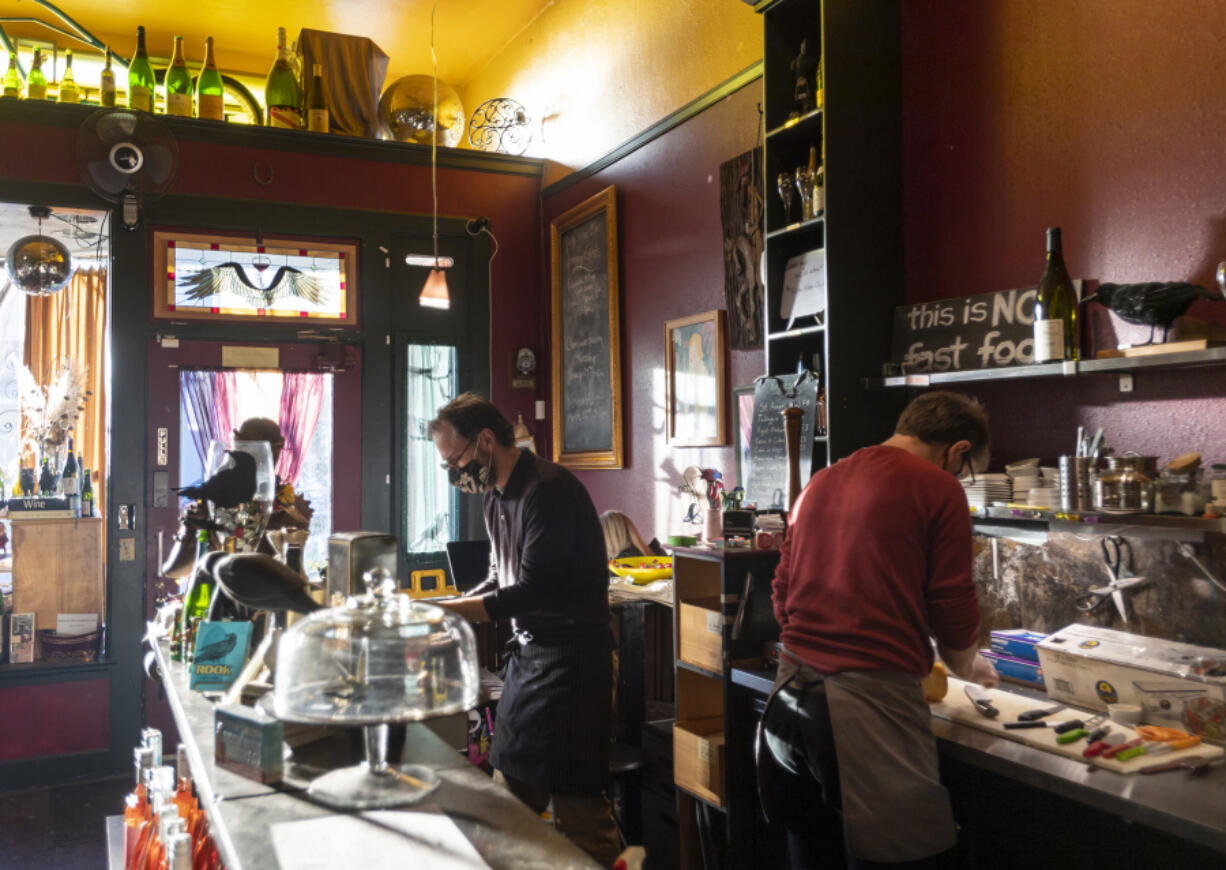 Employees prepare food and drinks for customers at Niche Wine Bar. The new location will feature a bigger kitchen.