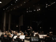 Maestro Salvador Brotons, facing, leads the Vancouver Symphony Orchestra during a concert at Skyview High School  (The Columbian files)