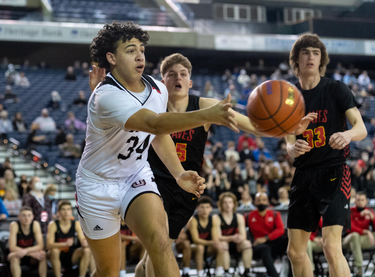 Union's Yanni Fassilis flips a pass to a teammate in a 4A State Boys Basketball quarterfinal game on Thursday, March 3, 2022, at the Tacoma Dome.