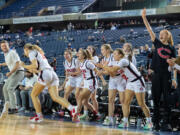 The Camas bench celebrates Riley Sanz's made 3-pointer in a 4A State Girls Basketball consolation game on  Friday, March 4, 2022, at the Tacoma Dome.