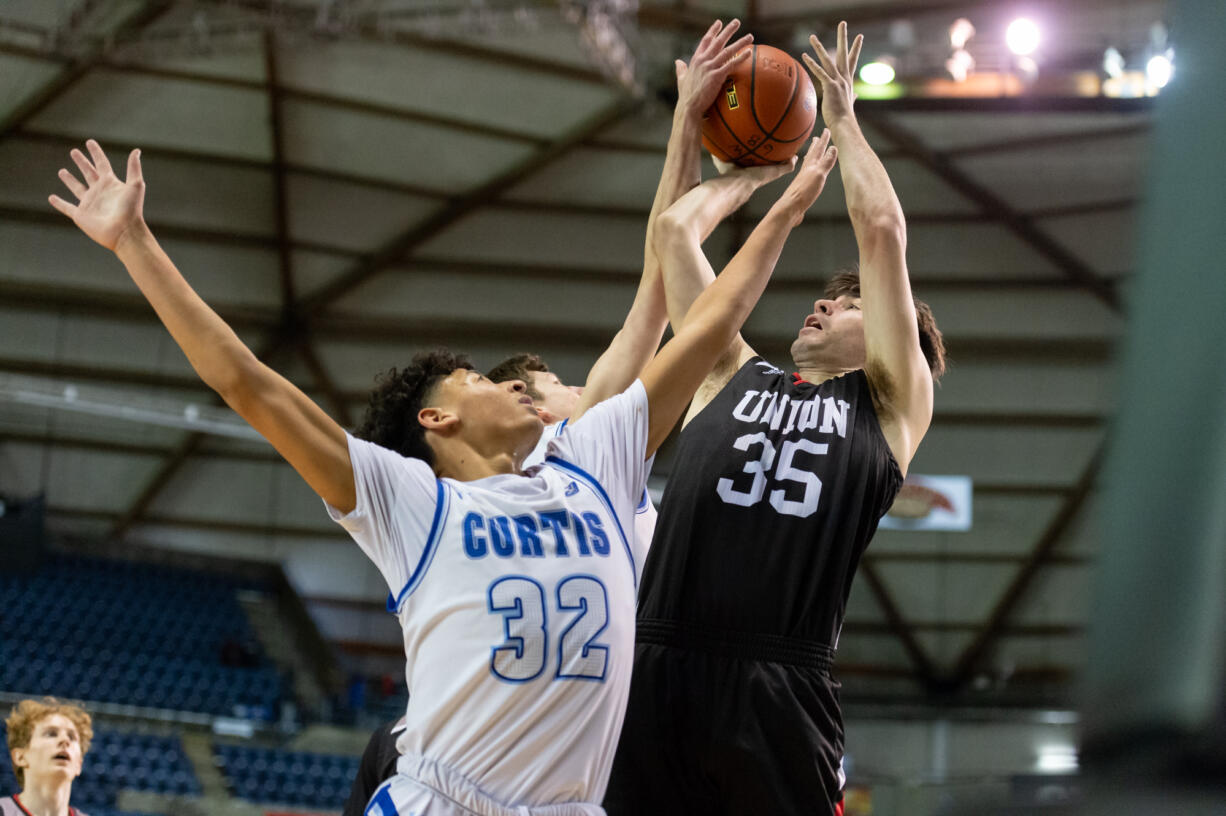 Union's Josiah Baldassare tries to shoot over a pair of Curtis defenders in a 4A State Boys Basketball semifinal on  Friday, March 4, 2022, at the Tacoma Dome.