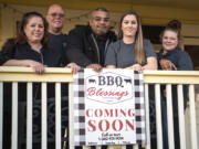 The BBQ Blessings staff stand on the front porch of their restaurant, which is set to open in April in the building that once housed Christine's Restaurant. Chef Judy Williams, from left, business partner Greg Williams, owners Kris and Jenny England, and manager Chyna Conner.