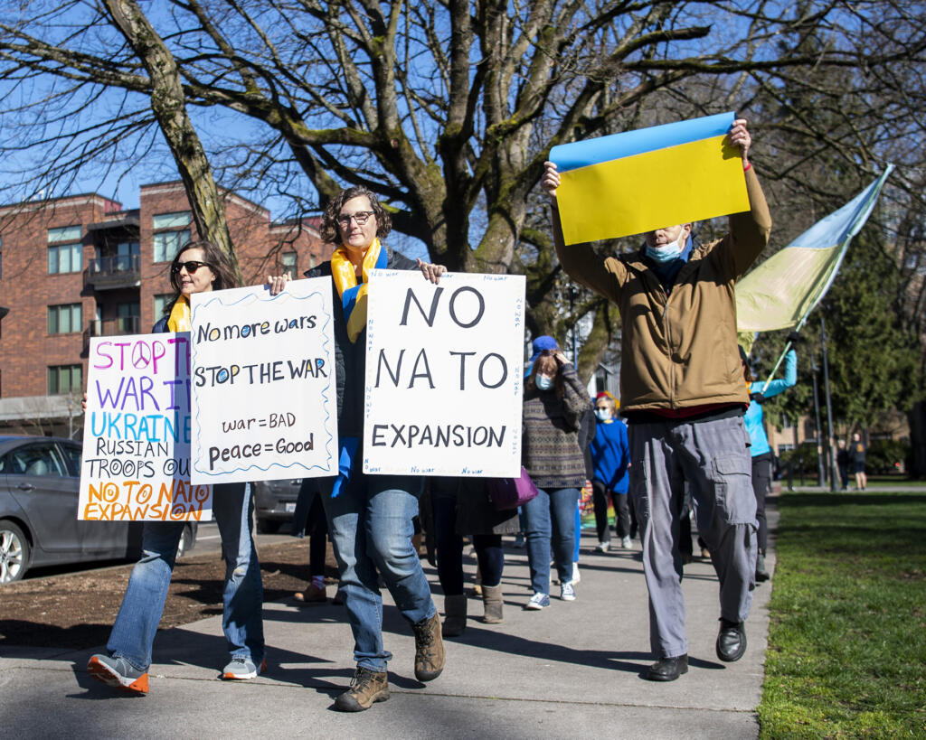 Protesters chant, hold signs and walk around Esther Short Park on Sunday during a rally to support Ukraine.