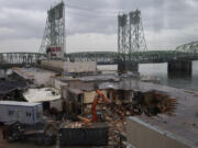 Demolition crews tear into a section of the former Red Lion at the Quay on Tuesday morning. The building's demolition will take four to six weeks.