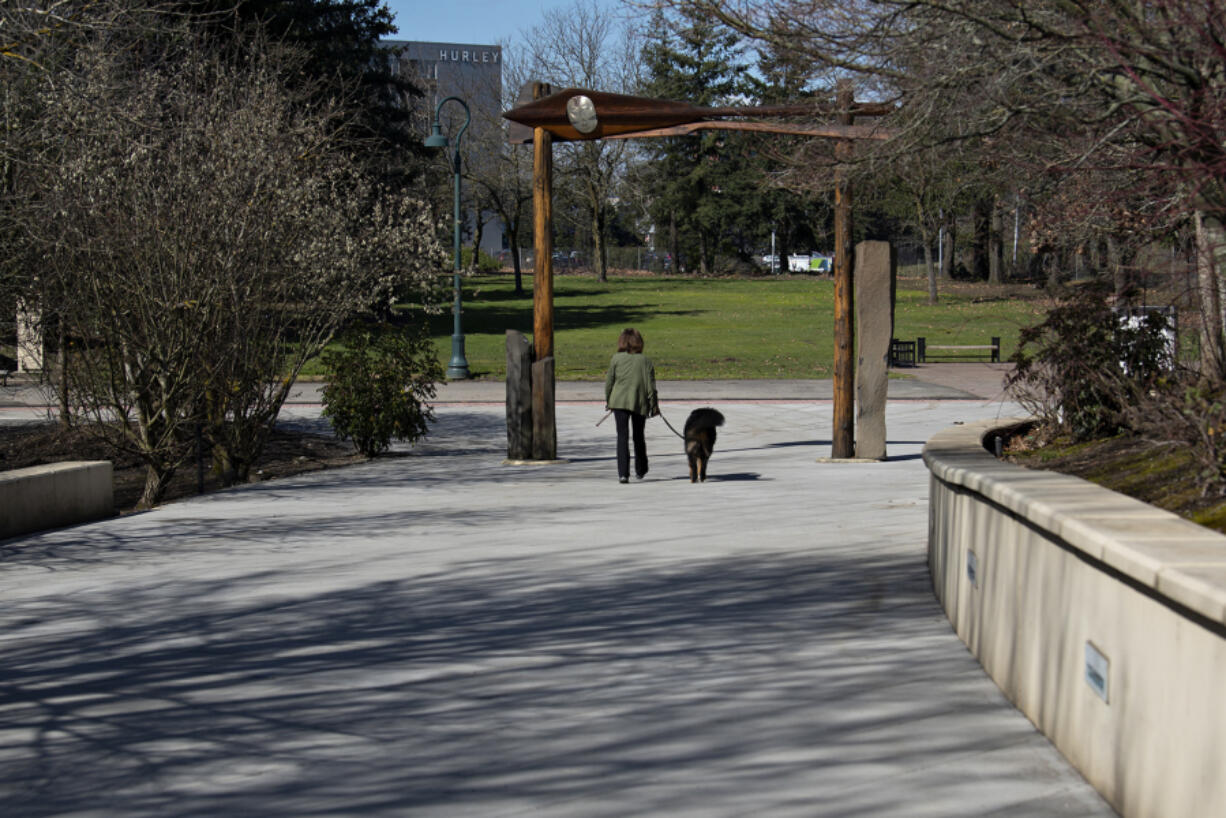 Vancouver resident Natalie Rieland strolls along the renovated Confluence Land Bridge with her dog, Rainier, 1, on Wednesday morning.