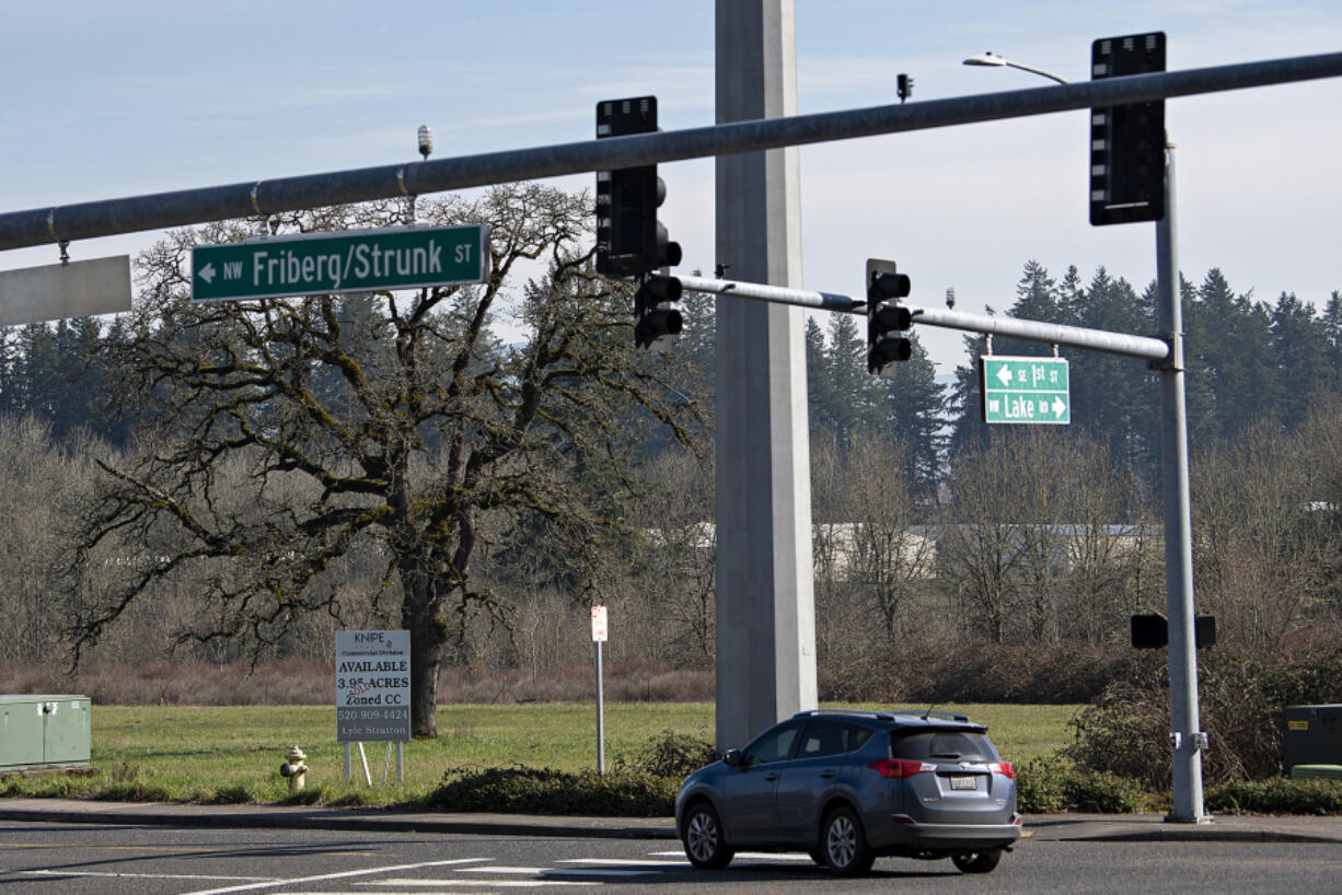 A motorist passes an empty lot that will soon be a new food truck center, Oak Tree Station.