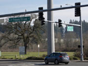 A motorist passes an empty lot that will soon be a new food truck center, Oak Tree Station.