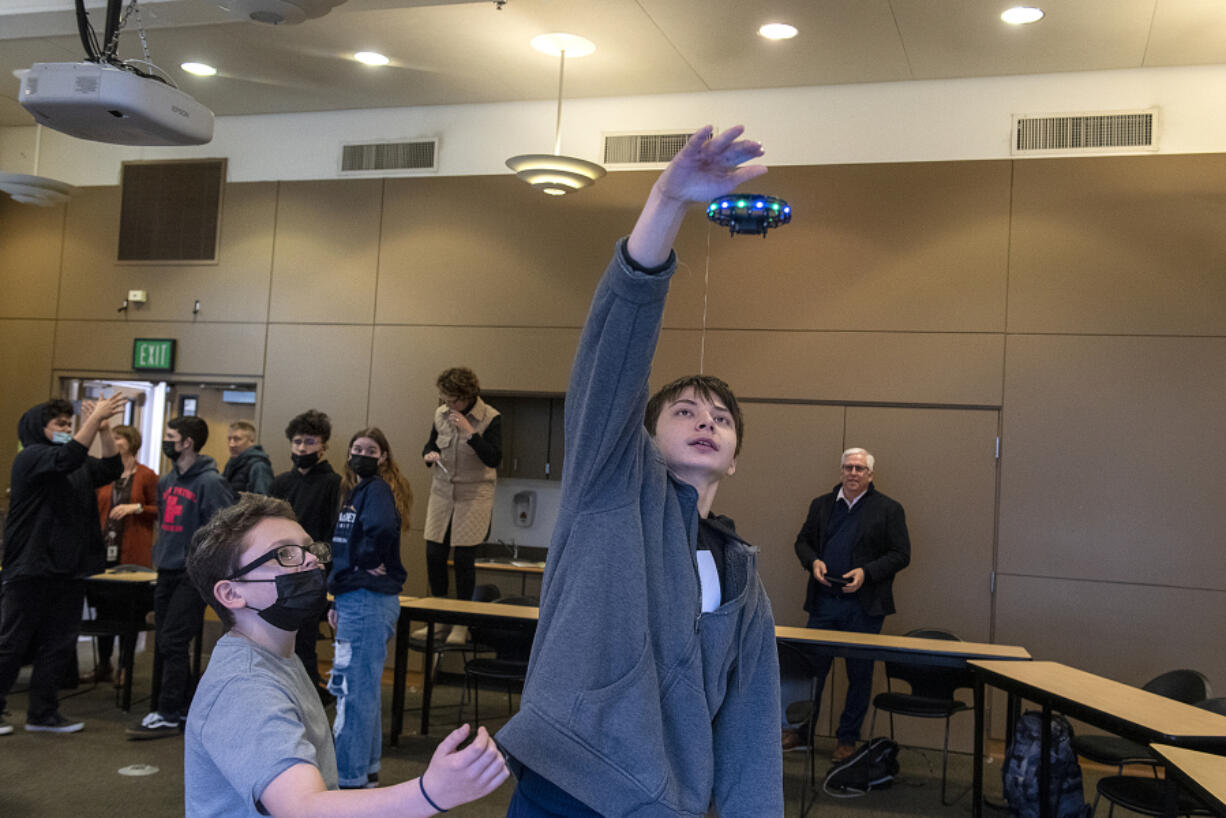 Fifth-grader D.J. Wilkins, left, and sixth-grader Urijah Fischer, get a chance to experience a toy drone during a presentation from Skanska, an international development and construction company, at the Washington School for the Deaf on Monday morning. The school is beginning the initial stages of its expansion and using it as an opportunity for students to engage with a new form of technology to help in the project.