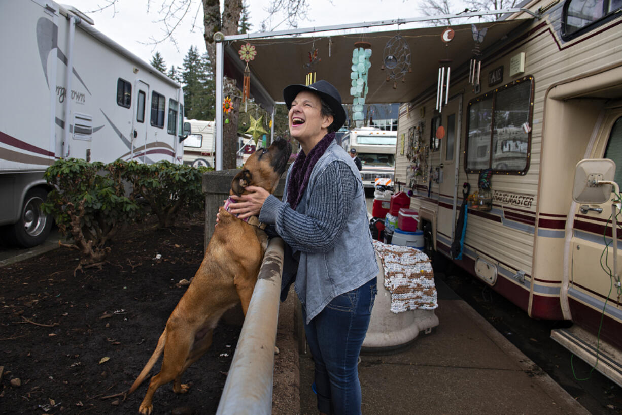 Raelene Boyle, who has used Vancouver's Safe Parking Zone for about a year, shares a playful moment with her dog, Liberty, 1 1/2 , on Wednesday. Boyle said the shelter program has been a lifesaver and gave her a chance for a new start. "All things can be made beautiful," she said.