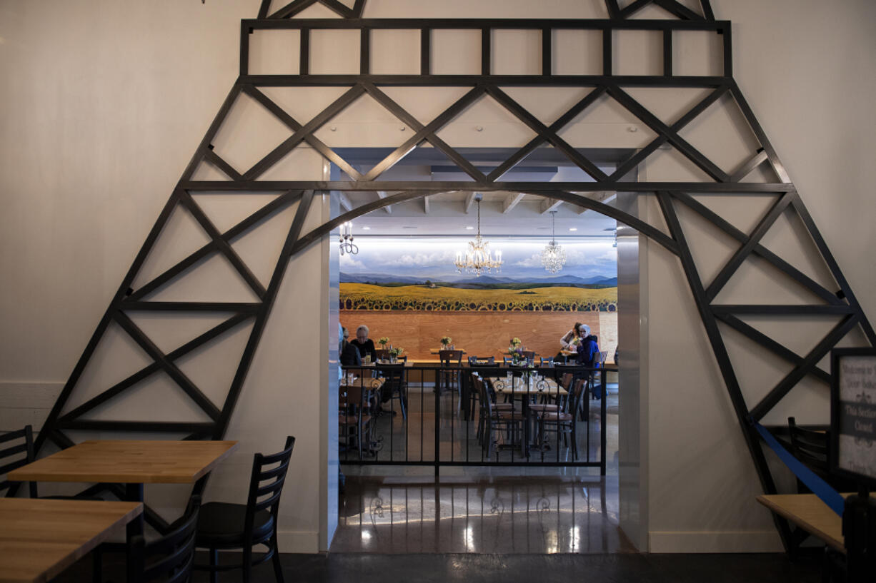 Artwork depicting the Eiffel Tower frames the dining room at Bleu Door Bakery in Vancouver. The Uptown Village bakery was closed for indoor dining during the pandemic but has since reopened and expanded.