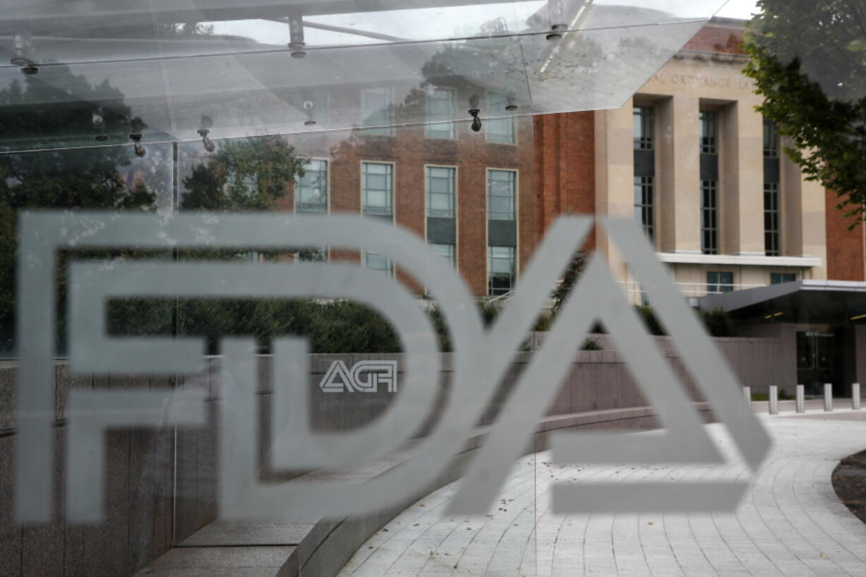 The U.S. Food and Drug Administration building is behind FDA logos at a bus stop on the agency's campus in Silver Spring, Md. The Food and Drug Administration has issued a negative review of a closely watched experimental drug for the debilitating illness known as Lou Gehrig's disease.