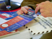 An election worker goes over a ranked choice voting explanation card with a voter before she casts her vote during early voting in the primary election in June 2021 in New York.