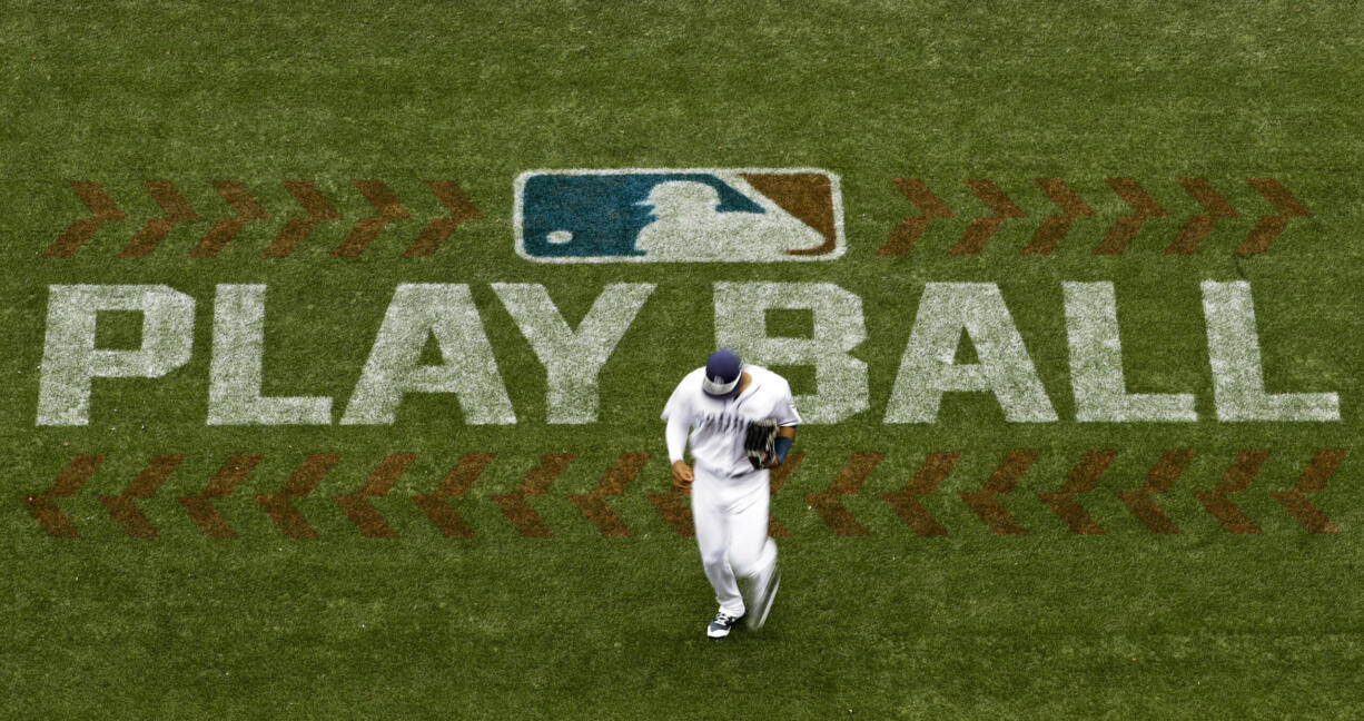 FILE - San Diego Padres left fielder Allen Cordoba passes a logo for Play Ball, an initiative from Major League Baseball and USA Baseball, during the fifth inning of a baseball game against the Colorado Rockies on June 3, 2017, in San Diego. Players voted Thursday, March 10, 2022, to accept MLB's offer on new labor deal, paving way to end 99-day lockout and salvage 162-game season.