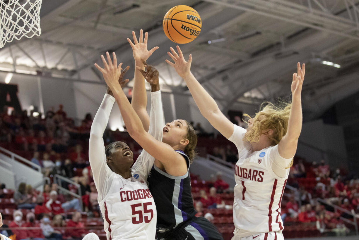 Washington State's Bella Murekatete (55) and Tara Wallack (1) battle for a rebound with Kansas State's Ayoka Lee, middle, during the first half of a college basketball game in the first round of the NCAA tournament in Raleigh, N.C., Saturday, March 19, 2022.