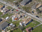 Homes are damaged after a tornado swept through, Wednesday, March 23, 2022, in Arabi, La. A tornado flipped cars, ripped off rooftops and deposited a house in the middle of a street in the New Orleans area, part of a storm front that caused damage in places as it blew from Texas to South Carolina.