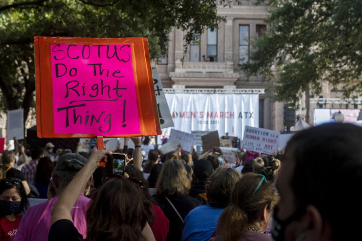 FILE - People attend the Women's March ATX rally, Oct., 2, 2021, at the Texas State Capitol in Austin, Texas. The Texas Supreme Court on Friday paved the way for the nation's toughest abortion law to remain in place in a ruling that again deflated clinics' hopes of stopping -- or even pausing -- the restrictions anytime soon.