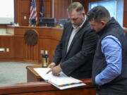Far-right activist Ammon Bundy, an independent candidate for Idaho governor, speaks with Nicholas Ramlow, right, during a break from defending himself against misdemeanor trespassing arrests in Ada County Magistrate Judge Kim Dale's courtroom Tuesday, March 15, 2022, in Boise, Idaho. In April 2021, Bundy was arrested twice in one day for entering the Idaho Capitol while under a one-year ban from the building stemming from an arrest in August 2020. Ramlow was an unsuccessful Libertarian candidate in in 2020 for a Montana House of Representatives seat.