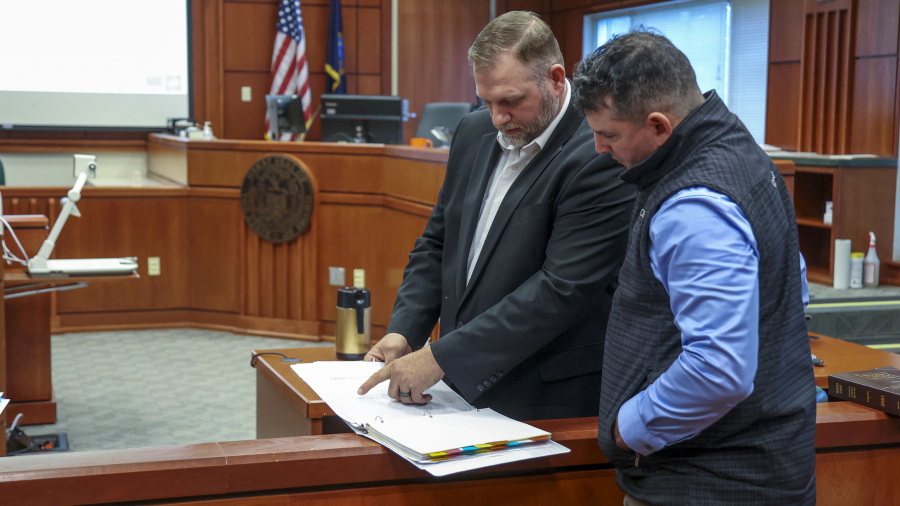 Far-right activist Ammon Bundy, an independent candidate for Idaho governor, speaks with Nicholas Ramlow, right, during a break from defending himself against misdemeanor trespassing arrests in Ada County Magistrate Judge Kim Dale's courtroom Tuesday, March 15, 2022, in Boise, Idaho. In April 2021, Bundy was arrested twice in one day for entering the Idaho Capitol while under a one-year ban from the building stemming from an arrest in August 2020. Ramlow was an unsuccessful Libertarian candidate in in 2020 for a Montana House of Representatives seat.