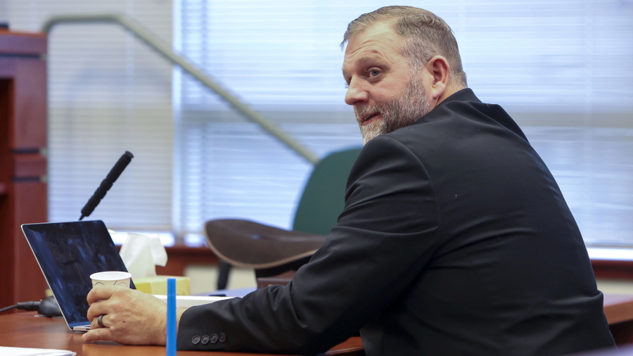 Ammon Bundy glances toward the prosecution table during a pause in his trial to clarify a line of questioning with the jury dismissed in Ada County Magistrate Judge Kim Dale's courtroom Tuesday, March 15, 2022, in Boise, Idaho. A major Boise hospital went on lockdown for about an hour Tuesday after far-right activist Bundy urged supporters to go the facility in protest of a child protection case involving one of his family friends.  Bundy, who is well-known for participating in armed standoffs with law enforcement, was arrested on Saturday on a misdemeanor trespassing charge after he protested at a different hospital where he believed the baby was being treated.