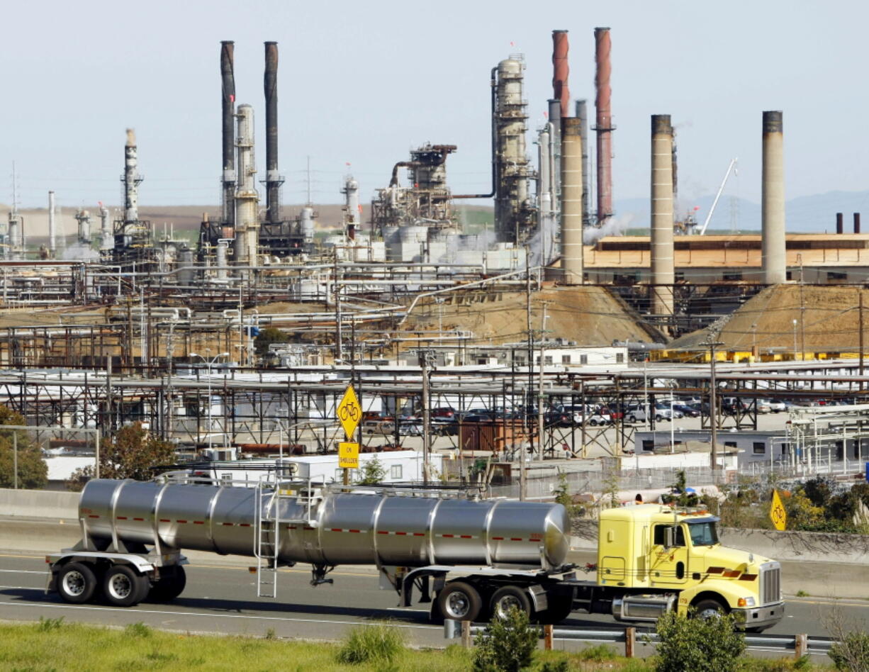 FILE - A tanker truck passes the Chevron oil refinery in Richmond, Calif., on March 9, 2010. More than 500 workers at the Chevron Corp. refinery in the San Francisco Bay area have told the company they will go on strike at 12:01 a.m. Monday, March 21, 2022. The United Steelworkers union says Sunday, March 20 that members of Local 5 voted down Chevron's most recent contract offer and gave notice of intent to go on strike.